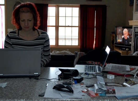 Photo by Nicole Helget. Look at all the clutter on the countertop! And Anderson Cooper on the TV! I don't do well working in pure silence; I usually need some type of quiet background noise.