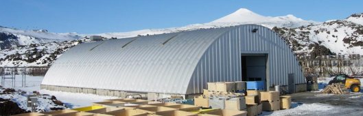 My grandpa's machine shed wasn't this big, but it was in this style. Snow would accumulate in those grooves and if the snow was hard enough, I could climb up. The shed wasn't this long, but the height looks about right!